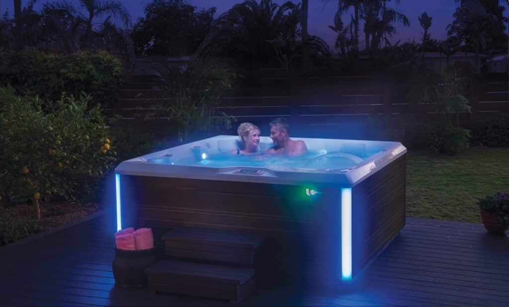 Whirlpool im Garten bei Nacht mit LED-Beleuchtung und entspannter Nutzungsszene – HotSpring